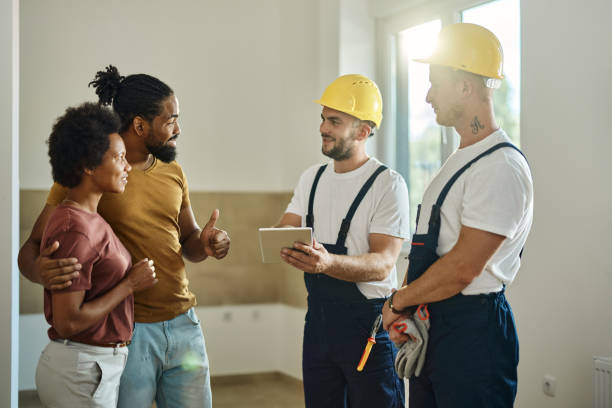 istock Happy black couple using touchpad manual workers at renovating apartment. 1513208734