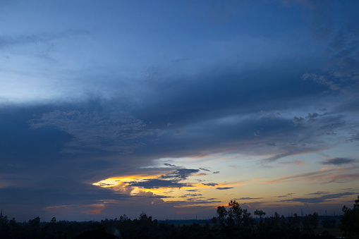 Sunset with dramatic sky and rainny clound with tree