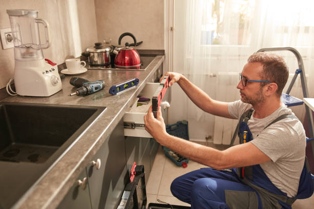 istock Handyman fixing kitchen cabinets in the apartment. 1513239543
