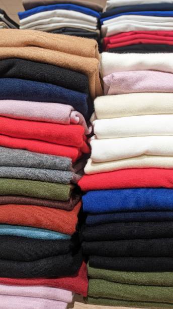 istock Different color fabrics stacked one on top of the other in a stack selling textiles in a store 1513251613