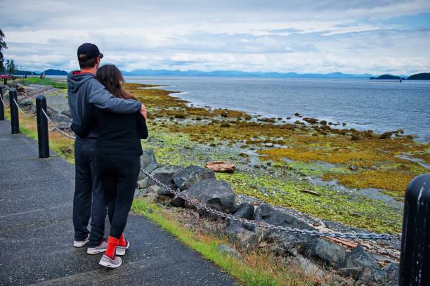 istock Couple standing on the beach 1513262204