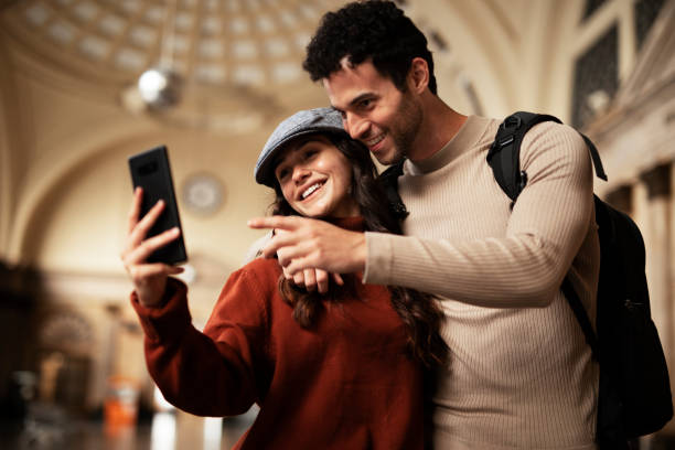 istock Young woman and man waiting to board a train. 1513280817