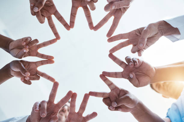 istock Peace, team building and hands of business people with star shape using teamwork, support and global solidarity. Collaboration, below and group of workers in a huddle with our vision in a company 1513285118