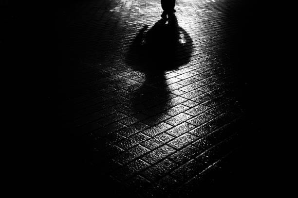 A rainy night, the shadow of a man
