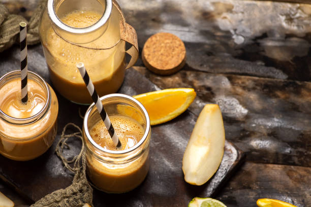 istock smoothies in a jar pear, orange and banana 1513312908