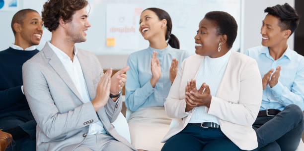 istock Support, motivation and success with a business team clapping during a workshop for learning, coaching and development. Collaboration, teamwork and goal with a crowd in celebration of an achievement 1513314893
