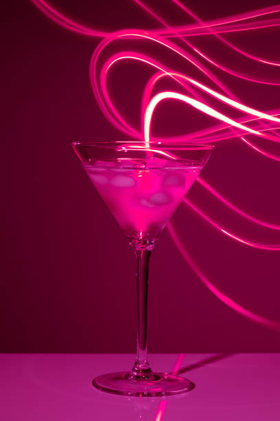istock Martini glass with drink and ice against creative lighting 1513316010