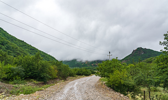 Wet dirt road in mountainous area