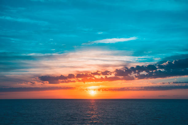 istock Sunset on the horizon and clouds illuminated by the setting sun 1513349860