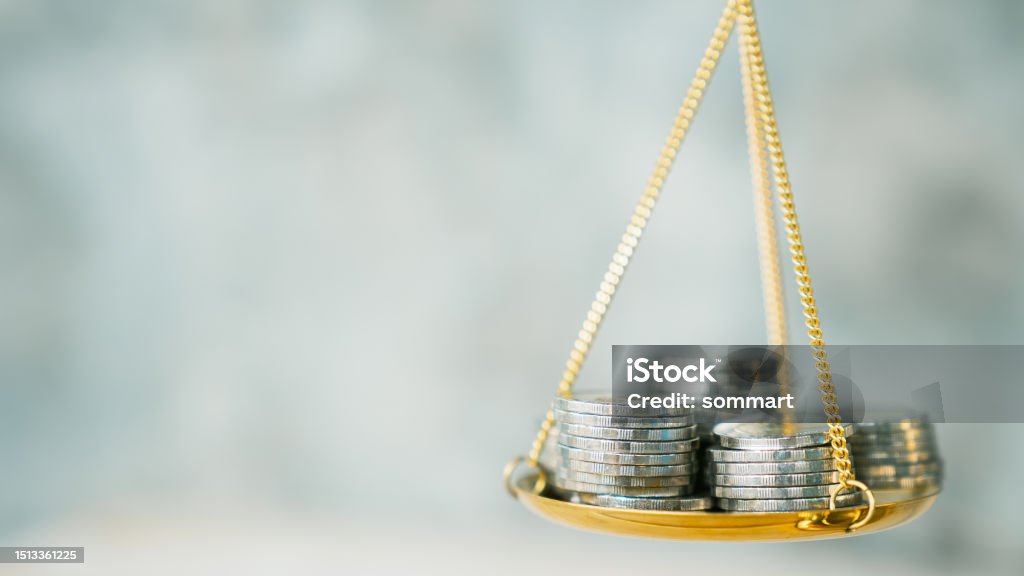 Coins stack with balance scale. Money management, financial plan, time value of money, business idea and Creative ideas for saving money concept. Price Stock Photo