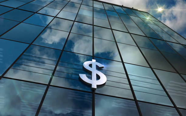 istock Dollar symbol money and bank glass building concept 1513367708