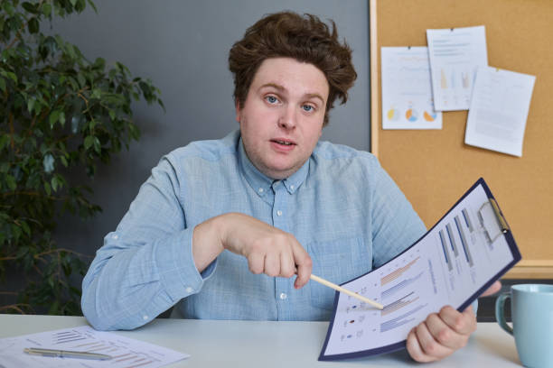 istock Businessman examining financial documents in office 1513367937