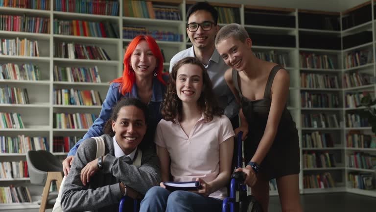 Diverse team of students inclusive classmate with disability posing