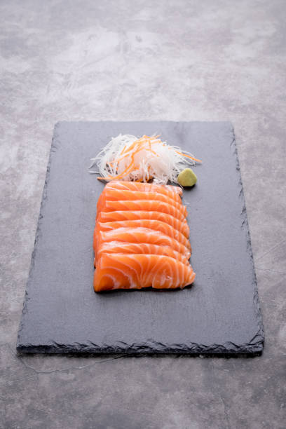 istock The salmon sashimi was laid out on a black stone plate 1513388544