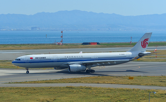 Osaka, Japan - Apr 18, 2019.   B-5947 Air China Airbus A330-300 taxiing on runway of Kansai Airport (KIX). Kansai is the 3rd busiest in Japan, with 25 million passengers.