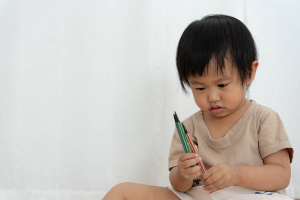 istock Happy Asia children playing learning paint on paper. Activity, development, IQ, EQ, meditation, brain, muscles, essential skills, family having fun spending time together. Holiday 1513404667