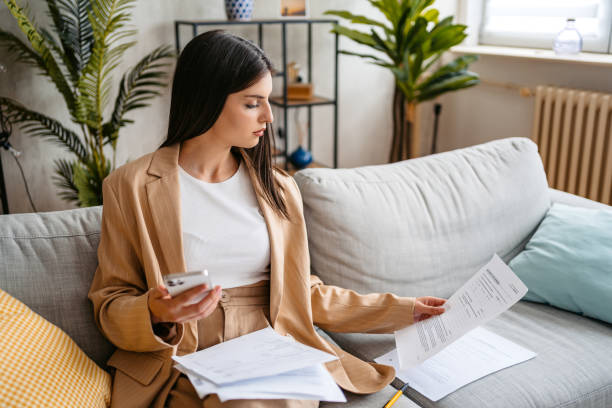 istock Young Woman Checking Her Finances Using Smart Phone At Home 1513410497