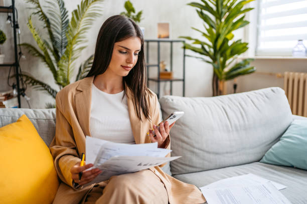istock Young Woman Checking Her Finances Using Smart Phone During Daytime 1513417469