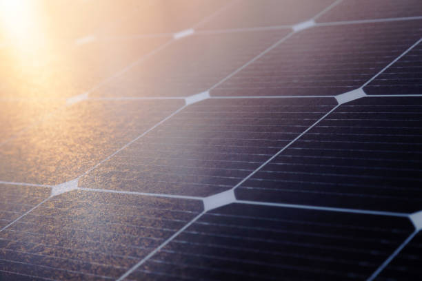 istock Solar panel close-up with the rays of the setting sun in the corner. 1513431788