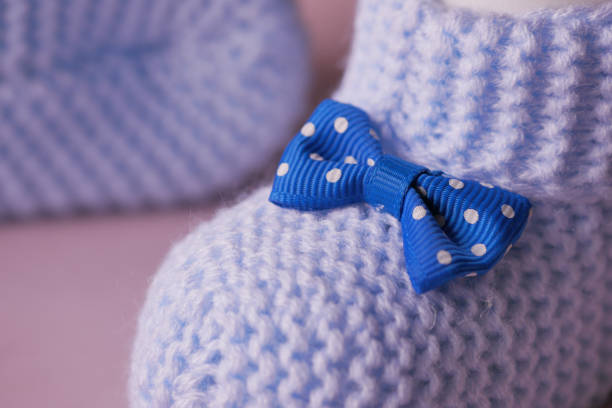 Knitted shoes for an infant. .