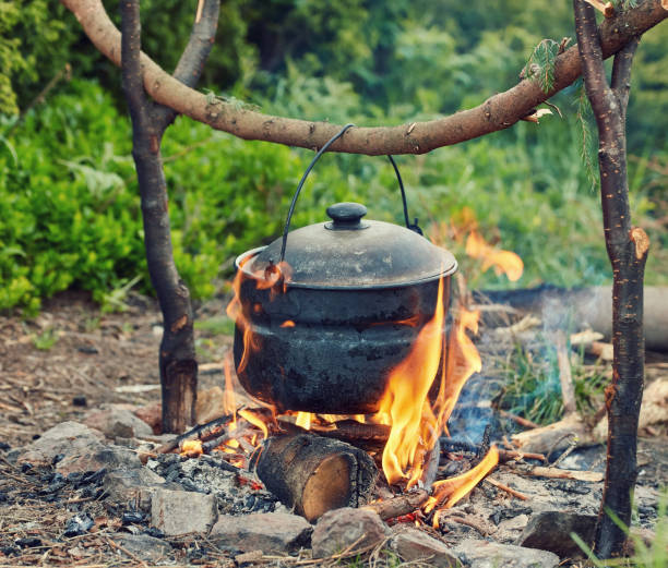 istock Cooking in field conditions, boiling pot at the campfire 1513455403