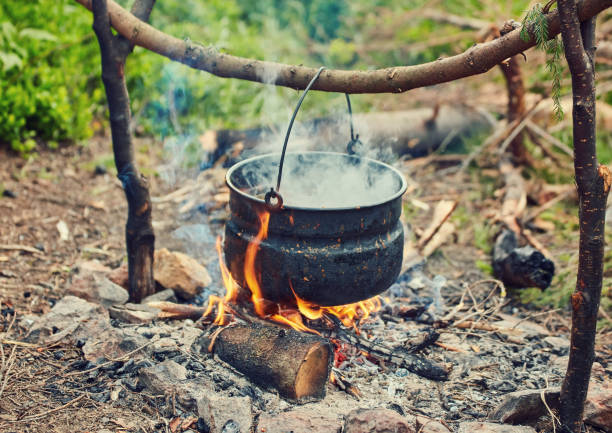 istock Cooking in field conditions, boiling pot at the campfire 1513455408