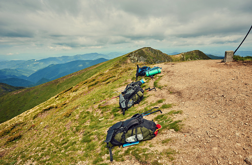 backpacks bags without people near the trail, tourists show them to walk light