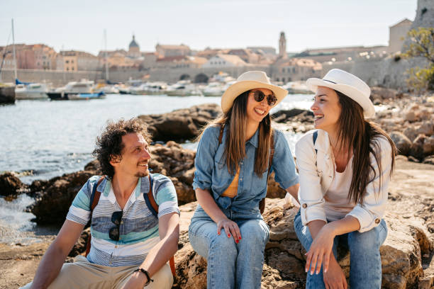 istock Three Young Friends Sitting On A Rock In Dubrovnik Bay 1513462072