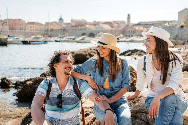 istock Three Young Friends Sitting On A Rock In Dubrovnik Bay 1513464820