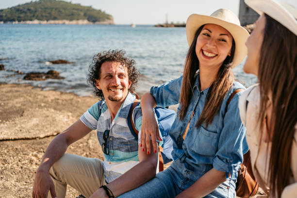 istock Three Young Friends Sitting On A Rock In Dubrovnik Bay 1513466947