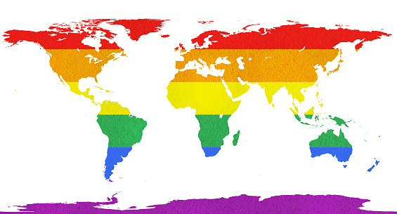 Rainbow Flag overlaid on a world map, with a subtle paper texture. Map outline adapted from public-domain source at https://commons.wikimedia.org/wiki/File:Blank_World_Map_circa-1985.png