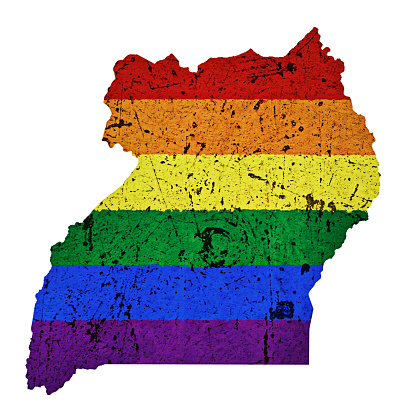 Scratched, distressed map of Uganda overlaid with the multi colored stripes of the gay pride flag. Map outline adapted from public-domain source at https://commons.wikimedia.org/wiki/File:Un-uganda.png