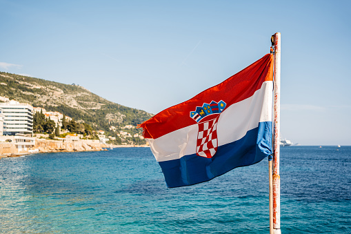 Croatian Flag waving in Dubrovnik Old Town bay in Croatia.