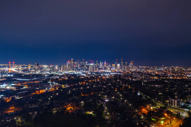 Melbourne CBD from Port Melbourne Cityscape of Melbourne from Port Melbourne at night port melbourne melbourne stock pictures, royalty-free photos & images