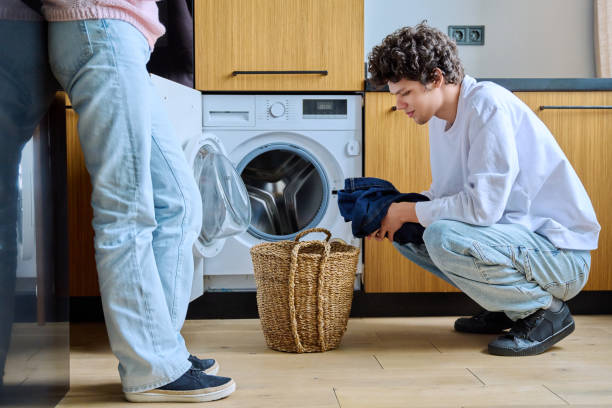 istock Young guy at home using washing machine with basket of dirty things 1513483563