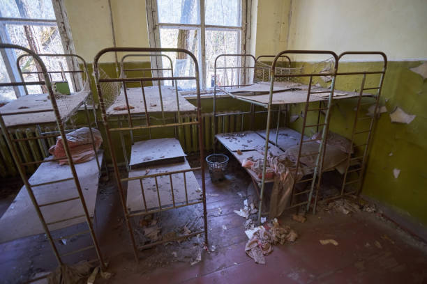 istock Room of empty metal bed frames in abandoned kindergarten 1513492132