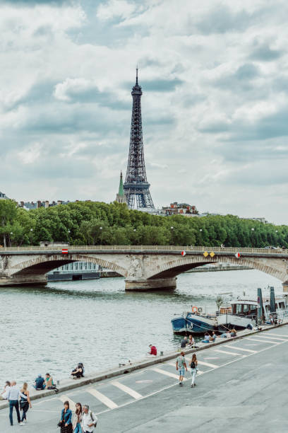 Paris, France - May 20, 2023: View of Eiffel Tower from the Seine. The Eiffel Tower (French: tour Eiffel) is a wrought-iron lattice tower on the Champ de Mars in Paris, France, and its tallest structure. It is named after the engineer Gustave Eiffel, whose company designed and built the tower. Locally nicknamed \