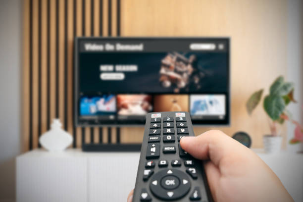istock Man watching TV with remote control in hand. 1513524122