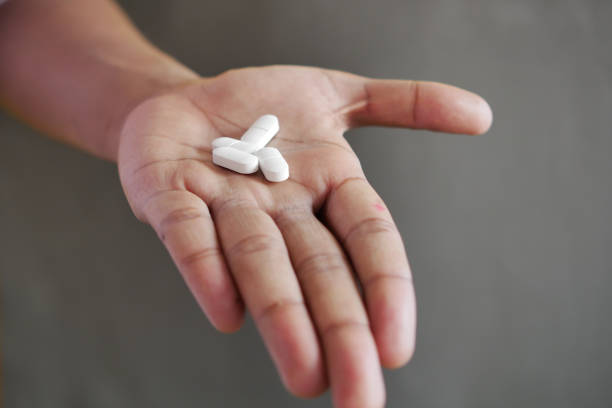 istock Close up of man hand holding pills with copy space 1513531778