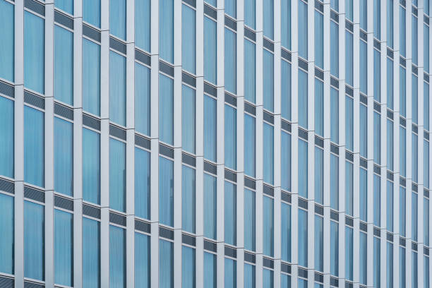 istock glass curtain wall facade of a modern building, with the sky reflected on its surface. 1513538833