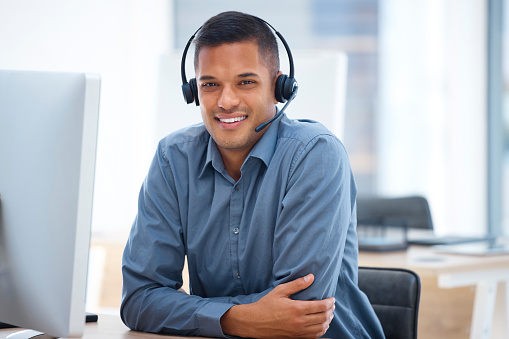Call center portrait, smile or happy man in communication for telecom customer services in crm office job. Contact us or friendly sales agent consulting on microphone in technical support help desk