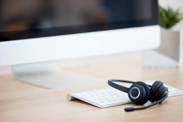 istock Call center help desk, computer or headset for communication for telecom customer services. Keyboard, background or crm office workplace for technical support, telemarketing sales or consulting job 1513565427