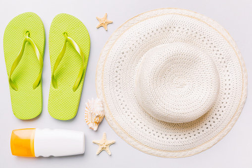 Summer vacation concept flat lay. straw hat beach accessories and towel top view. Space for text. travel concept.