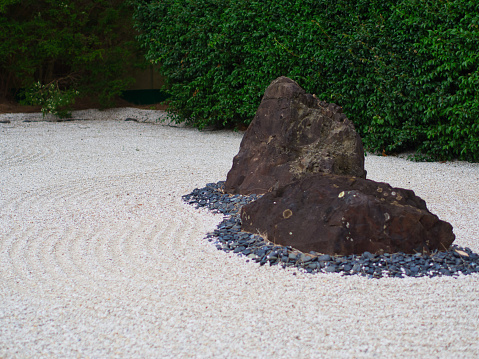 Japanese rock garden consists of two boulders, lined with pebbles and Zen engraved gravels, combined to display a peaceful setting.