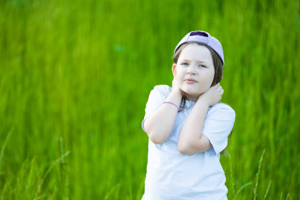 Only One Young Girl with blue shirt. Grass in Background. Poland.