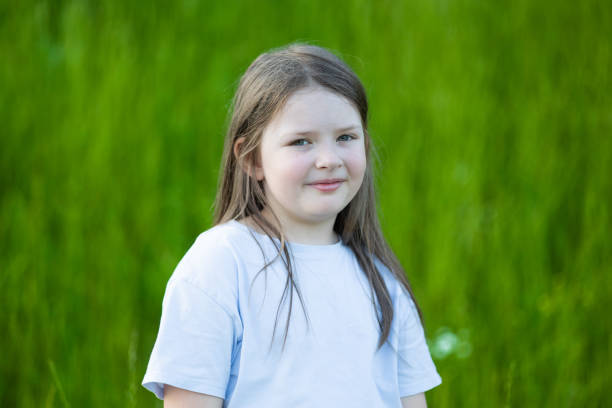 istock Young Girl on Grass Background 1513667944