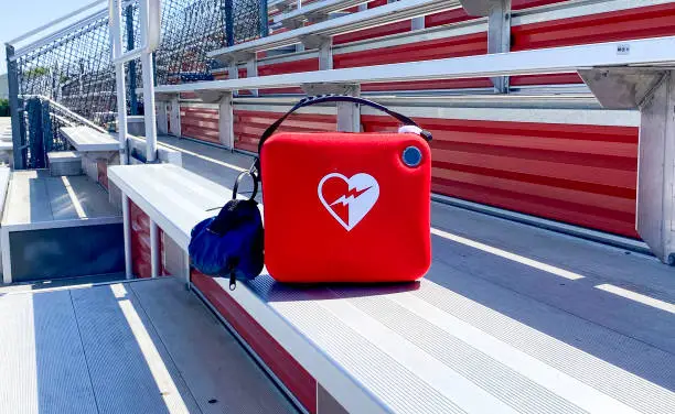 A life saving AED difibrillator in the bleachers for the protection of athletes, coaches and fans.