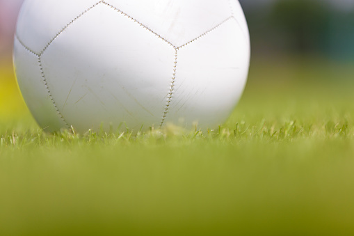 Closeup on White Soccer Training Ball on Grass Field. Football Practice Ball Detail Image