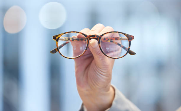 istock Optometry, vision and optometrist hand with glasses for eye care, optical wellness and healthcare. Medical, optic and closeup of woman with spectacles with stylish frame and prescription lens in shop 1513708426