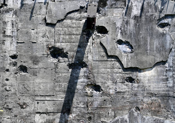 battle damage on a concrete wall - impact holes of small and large calibre weapons (Japanese WWII bunker in Palau)